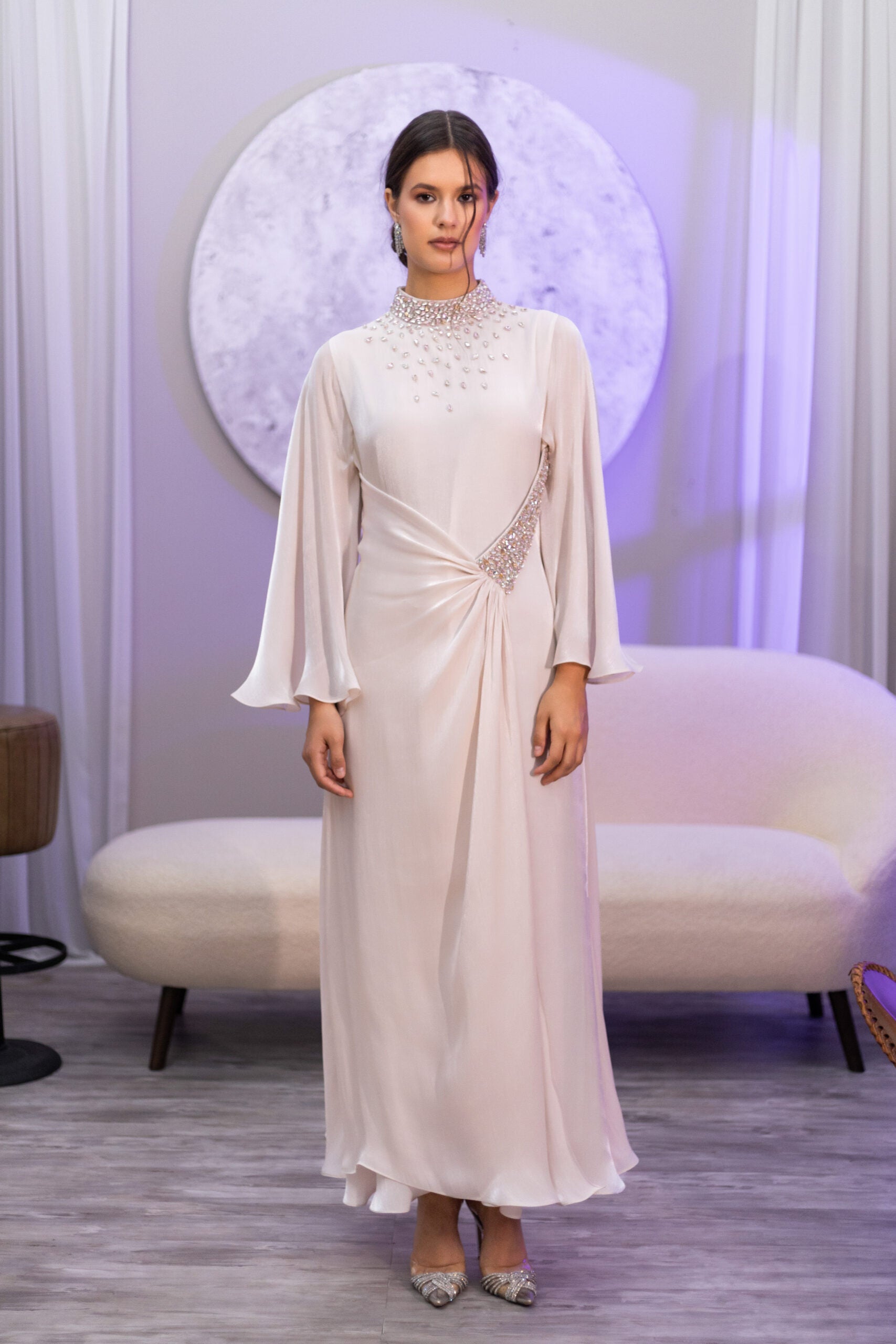 Woman wearing a long, elegant dress with a blurred background